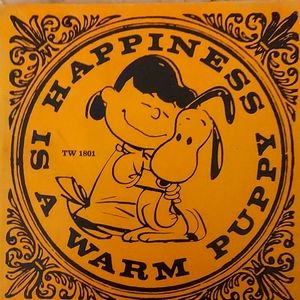A Snoopy Book called, "Happiness is a Warm Puppy.